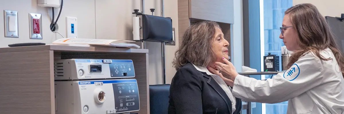 Gillespie, Manager, Advanced Practice Providers, examines her patient's neck in an MSK exam 