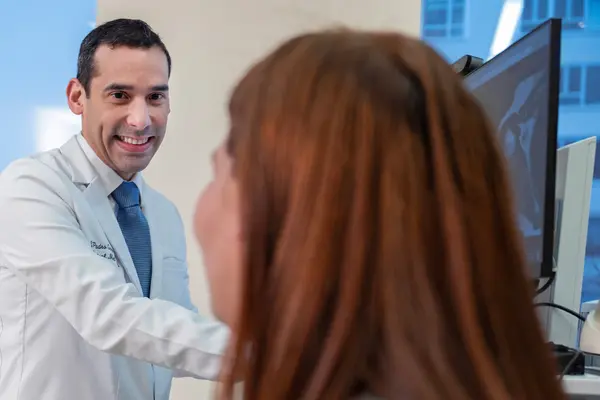 Rehabilitation medicine doctor Jesuel Padro-Guzman is with his patient at MSK in New York City.  