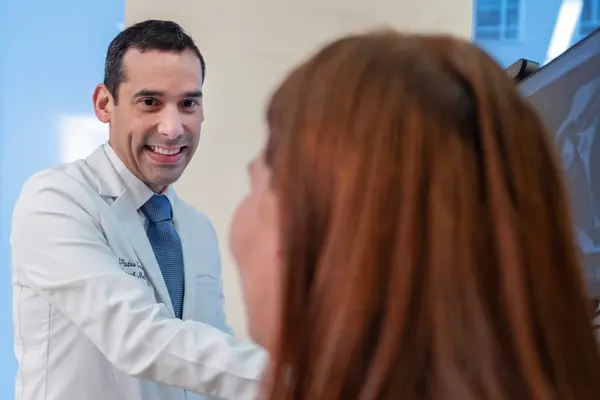 Rehabilitation medicine doctor Jesuel Padro-Guzman is with his patient at MSK in New York City.  