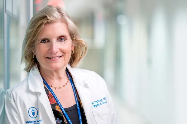 MSK gastrointestinal oncologist Dr. Deb Schrag is in a hallway at MSK in New York City.    