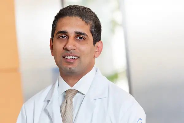  Headshot of radiation oncologist Dr. Nadeem Riaz at MSK in NYC, wearing a doctors’ white coat. 