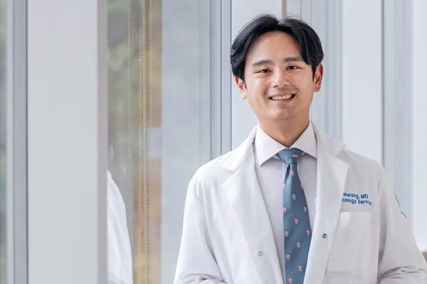 Head and neck medical oncologist Dr. Michael Hwang talks with his patient at MSK in Commack on Long Island. 