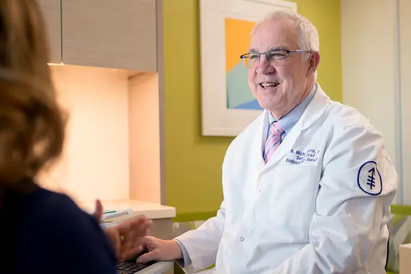Dr. Michael Tuttle, wearing a white doctor’s coat, in an exam room at MSK.