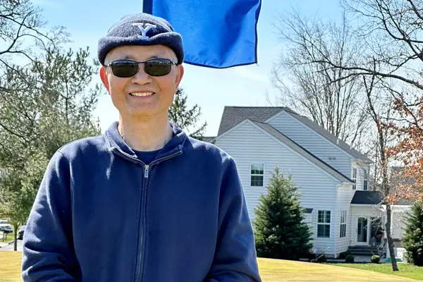 Prostate cancer survivor Dr. Shieh, outdoors at a golf course. 