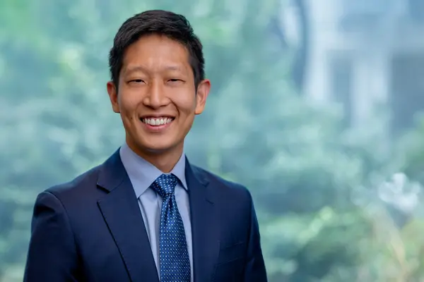  Dr. Gao at MSK in NYC, wearing a business suit. 