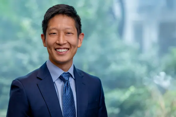 Dr. Gao at MSK in NYC, wearing a business suit. 