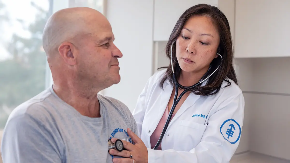 Thoracic medical oncologist Dr. Juliana Eng examines a lung cancer patient.