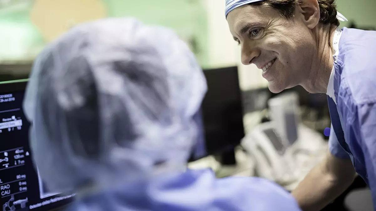 The chief of the Interventional Radiology Service consults with a colleague as they view imaging tests.