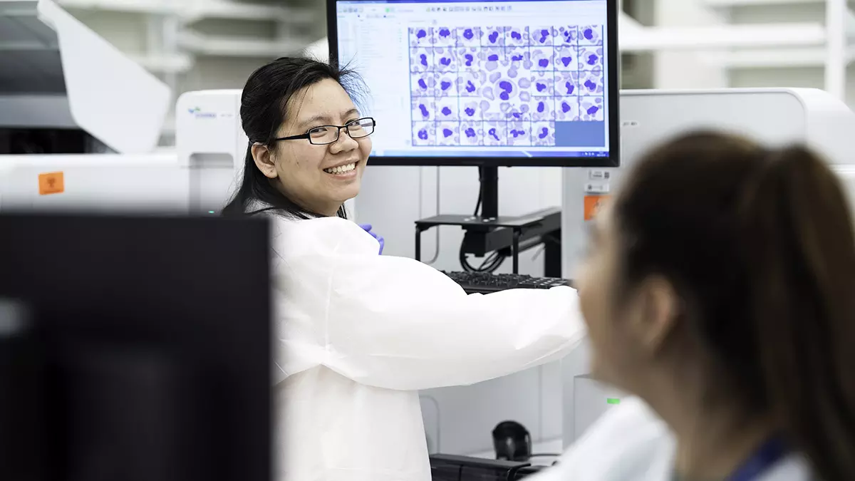 A specialist shares a smile with a colleague in the Rapid Response Lab, designed to make care quicker and more convenient for patients.