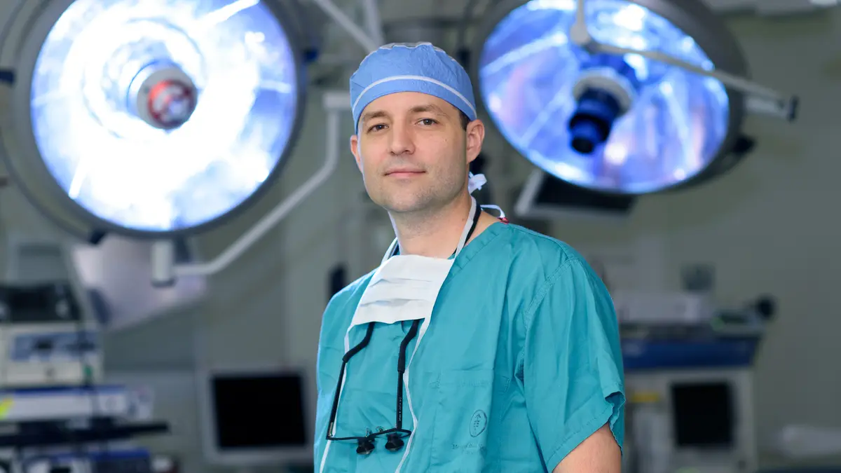 Head and neck surgeon Dr. Brian R. Untch, in surgical scrubs, is in an MSK surgical suite.  