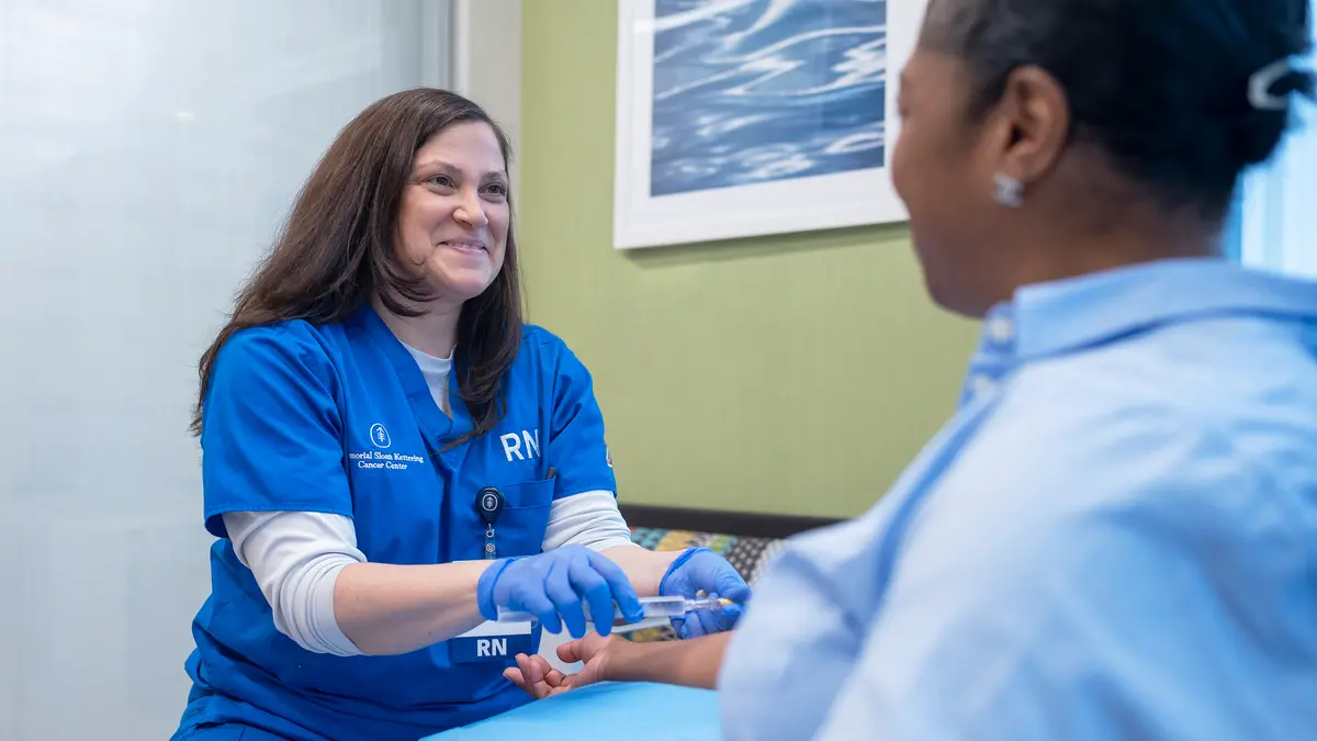 An MSK registered nurse gives infusion treatment to her patient 