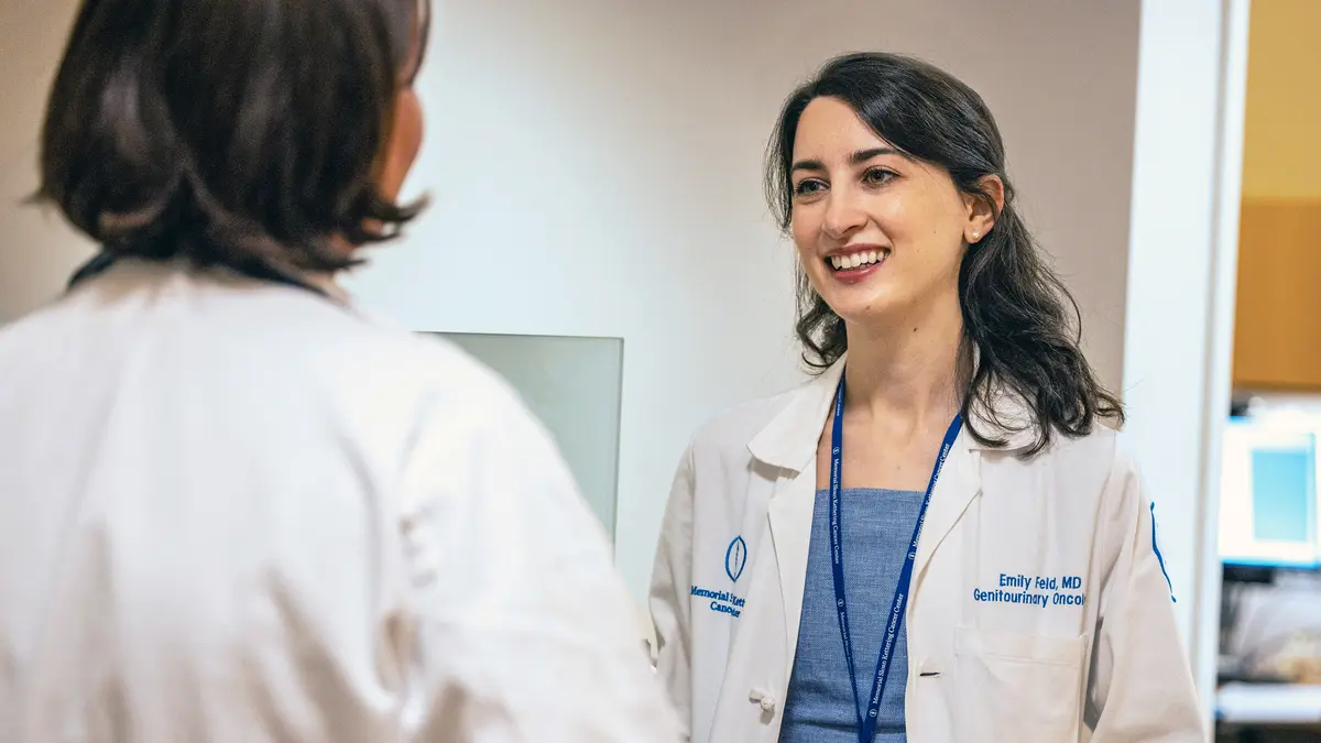 Two female MSK prostate cancer experts talking in an MSK exam room. 