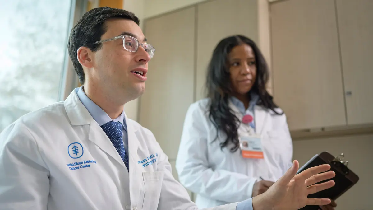 Urologic surgeon Dr. Jonathan S. Fainberg and nurse practitioner Desiree Robinson are in an exam room. 