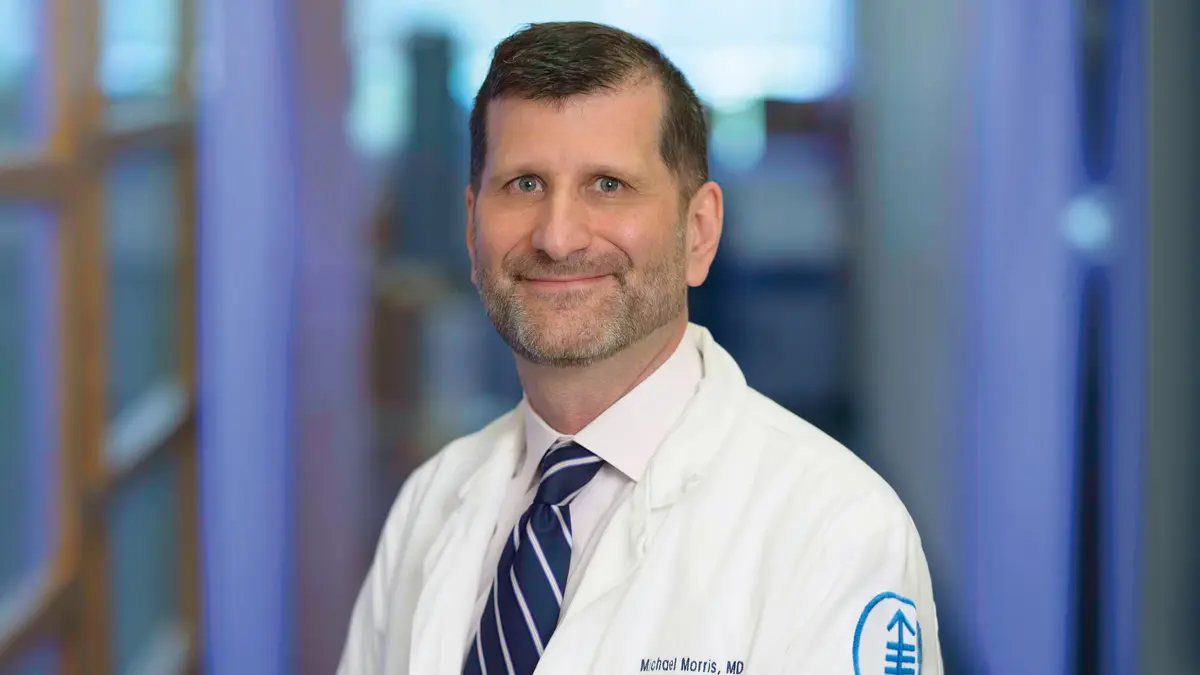 Genitourinary medical oncologist Dr. Michael Morris, standing in an MSK hallway, is part of a new MSK program for improving treatment for neuroendocrine cancers. 