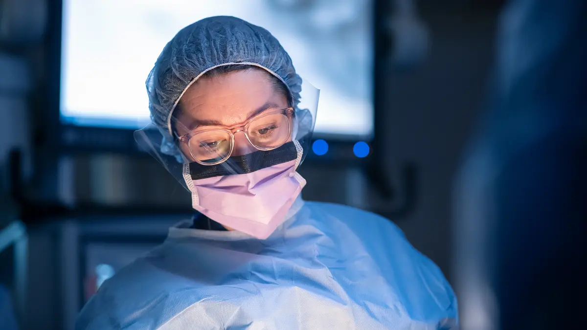 A care team member wearing surgical protection gear during a robotic prostatectomy. 