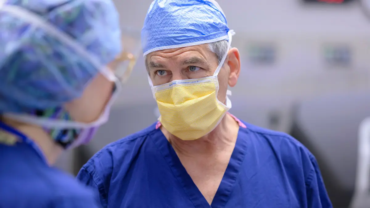 An MSK urologic surgeon in surgical gear preps to start robotic prostatectomy surgery. 